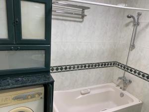 a bathroom with a tub and a sink at شارع لبنان - المهندسين - القاهرة مصر in Cairo