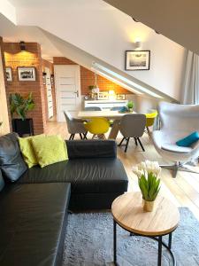 a living room with a couch and a table at Apartament MoLoo II in Ostróda