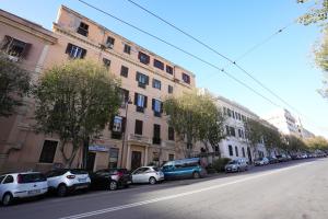 a street with cars parked on the side of a building at Rosetta Burger Queen in Cagliari