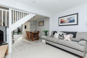 a living room with a couch and a table at Propeller house in Wargrave