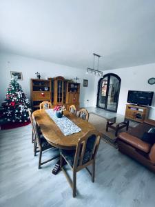 a living room with a table and a christmas tree at Casa POTE in Covasna