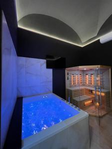 a large blue tub in a room with a shower at Suite Élite in Catania