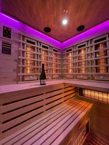 a wine bottle sitting on a bar in a sauna at Suite Élite in Catania