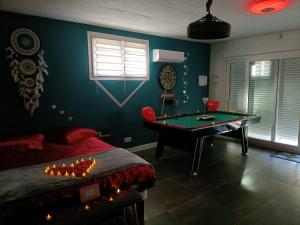 a bedroom with a pool table and a bed at Bulle d'évasion in Trèbes
