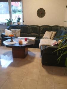 a living room with a couch and a coffee table at Ferienwohnung Wendel in Erbach im Odenwald