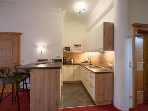 a kitchen with white cabinets and a counter top at Ferienhaus Willms am Gaisberg in Kirchberg in Tirol