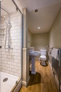 a bathroom with a toilet and a sink and a shower at Edgcumbe Arms in Torpoint