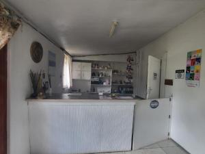 a kitchen with a white refrigerator and a counter at Eden Guest Farm in Bloemfontein