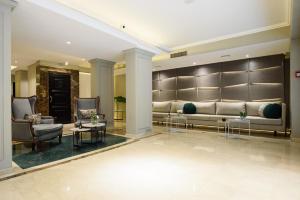 a lobby with a couch and chairs and tables at SuMa Recoleta Hotel in Buenos Aires