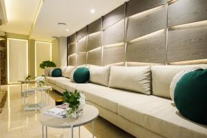 a living room with a couch and two tables at SuMa Recoleta Hotel in Buenos Aires