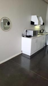 a kitchen with a sink and a mirror at Gorgeous in Johannesburg