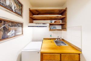 a kitchen with a wooden counter top and a sink at The Summit: 46 in Warren +47 photos