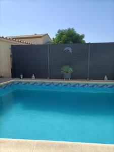 a swimming pool in front of a fence at Bulle d'évasion in Trèbes +18 photos