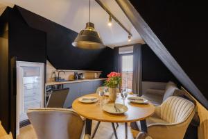 a kitchen and dining room with a table and chairs at Villa 84 & Apartments Jacuzzi & Sauna in Zakopane