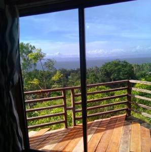 um quarto com vista para a floresta a partir de uma janela em Vida Kristele Bohol em Loon