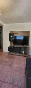 a living room with a large flat screen tv at Casa para viajes de descanso o de negocios in Quetzaltenango