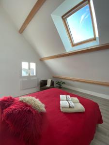 a bedroom with a red bed with a window at T2 Duplex Châtelaillon-Plage in Châtelaillon-Plage
