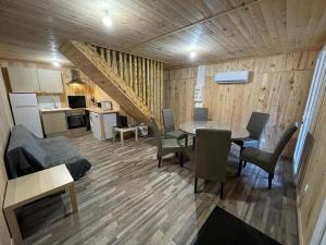 a living room with a table and a kitchen at Chalet Nala in La Bresse