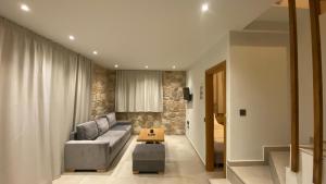 a living room with a couch and a table at VILLAS BALATSOURAS in Paleros