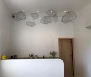 a room with a white wall with paper hearts on the wall at VILLAGE - DUPLEX lumineux avec vue magnifique sur les toits in Saint-Tropez