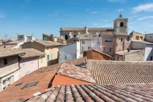 a view from the roofs of a city at La Tour 1 Appartement au coeur du centre ville in LʼIsle-sur-la-Sorgue