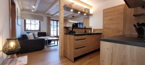 a kitchen with a counter and a living room at Hochalmbahnen Chalets Rauris 1-16 WE1, Maislaufeldweg 1p EG in Rauris