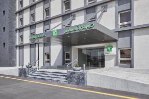 a building with a sign on the front of it at Holiday Inn Tabuk, an IHG Hotel in Tabuk
