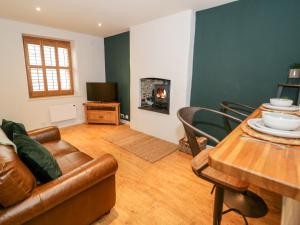 a living room with a couch and a table at 14 Llewelyn Street in Conwy