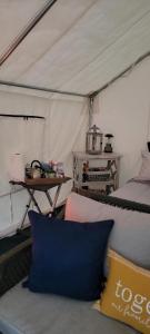 a room with a couch and a table in a tent at Tentrr Signature Site - Glamping in The Hamptons in Hampton