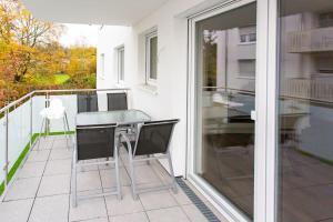 a patio with a table and chairs on a balcony at Große COZY 4-Zi-Whg mit Balkon Nähe Europa Park und Rulantica in Lahr +11 photos