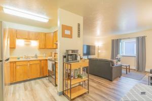 a kitchen and living room with a couch and a microwave at Centrally Located Comfort And Coffee 3 in Fairbanks