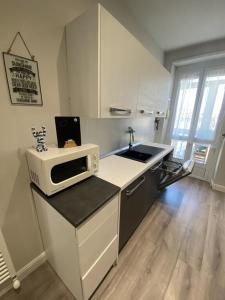 a kitchen with a sink and a microwave on a counter at FRESH HOME in Turin