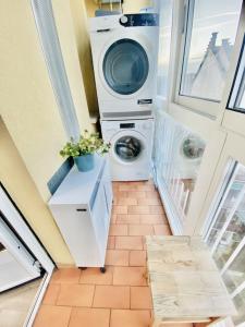 a laundry room with a washer and a washing machine at FRESH HOME in Turin