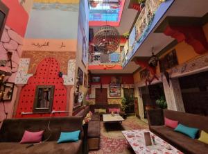 a lobby of a restaurant with couches and tables at Hostel Marrakech Rouge in Marrakech