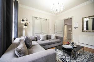 a living room with a couch and a table at Liverpool Georgian Town House Catharine St in Liverpool