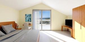 a bedroom with a bed and a view of the ocean at Golden Residence Family Resort in Pefkohori
