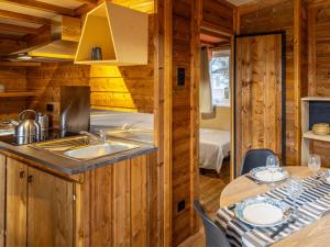 a kitchen with a sink and a table in a cabin at Domaine de la Forge in La Teste-de-Buch