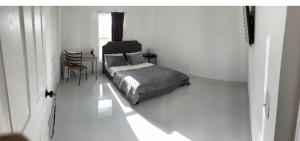 a bedroom with a bed and a table and a chair at Boca Raton home in Boca Raton