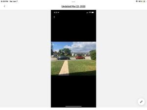 a screenshot of a cell phone screen with a picture of a car at Boca Raton home in Boca Raton