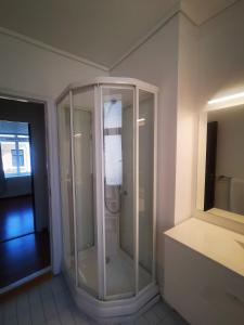 a glass shower in a room with at Inner City Center in Bergen