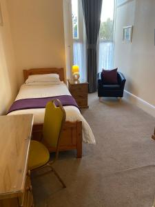 a bedroom with a bed and a chair and a desk at Paignton Court in Paignton +99 photos