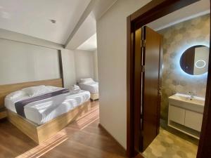 a bedroom with a bed and a sink and a mirror at Concept Royal Edirne in Edirne