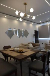 a living room with a table and a couch at Luxurious and Central Apartment 2Br in Xalapa