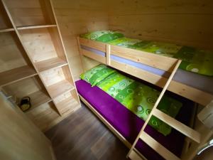 an overhead view of two bunk beds in a room at Wooden lodge with jacuzzi in Rečica ob Savinji