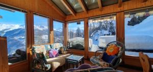 a living room with a view of a snowy mountain at LUMA in Les Collons