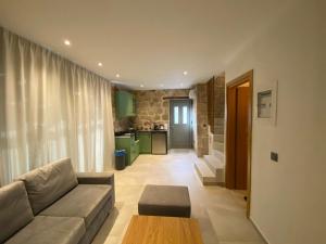 a living room with a couch and a table at VILLAS BALATSOURAS in Paleros