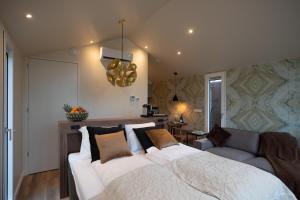 a bedroom with a large bed and a couch at Herberg Restaurant 't Zwaantje in Mook