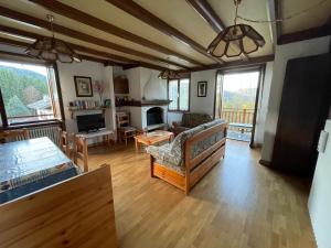 a living room with a couch and a table at Santi’s Apartment in Folgaria