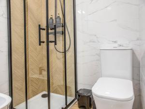 a bathroom with a shower with a toilet and a sink at tuGuest Avenida Madrid in Granada