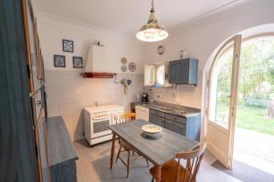 a kitchen with a table and a small kitchen with a window at Aurora Holiday House in Vasto